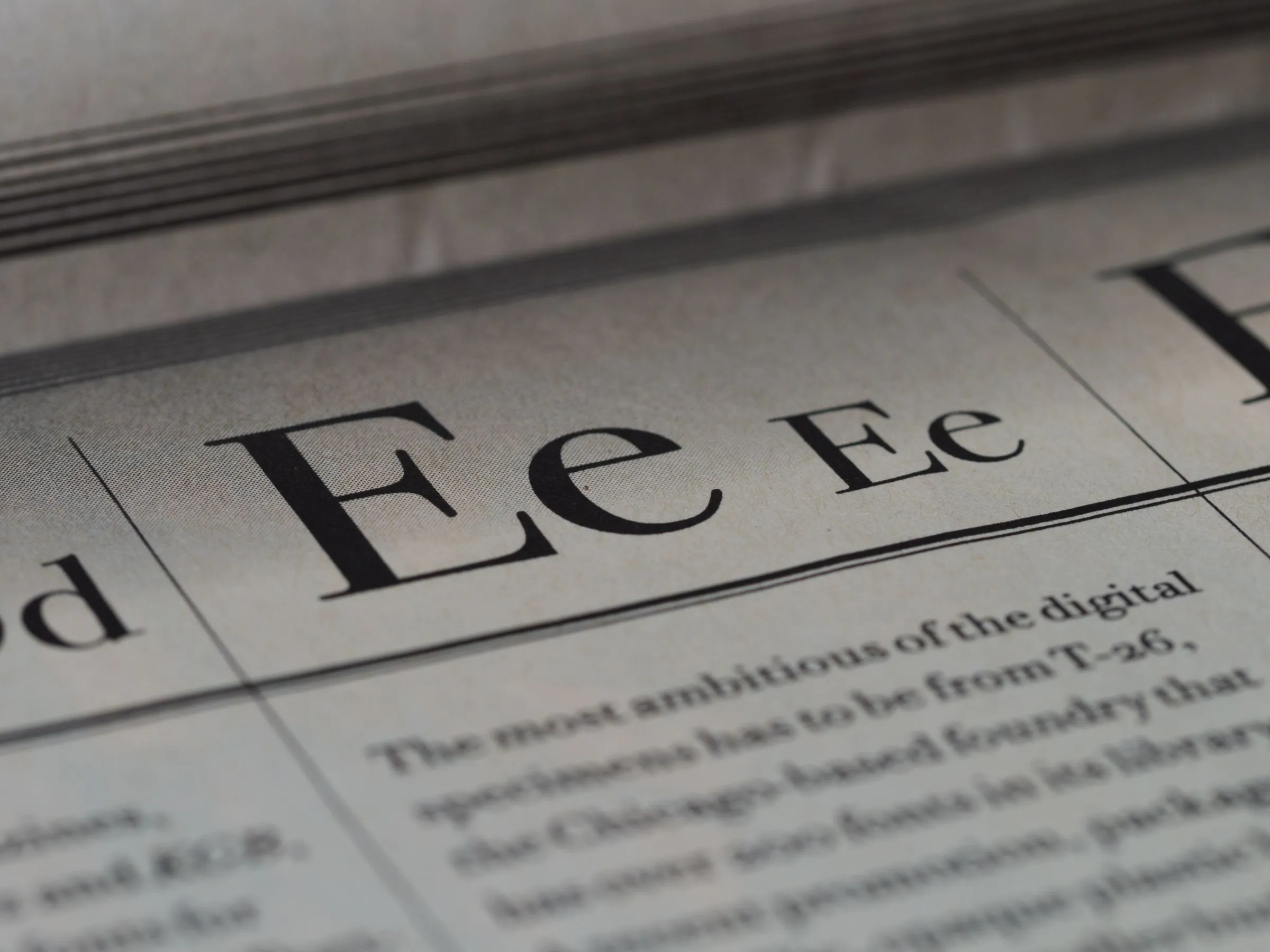 Close-up of a printed type specimen showing large serif letters E and e above body text.
