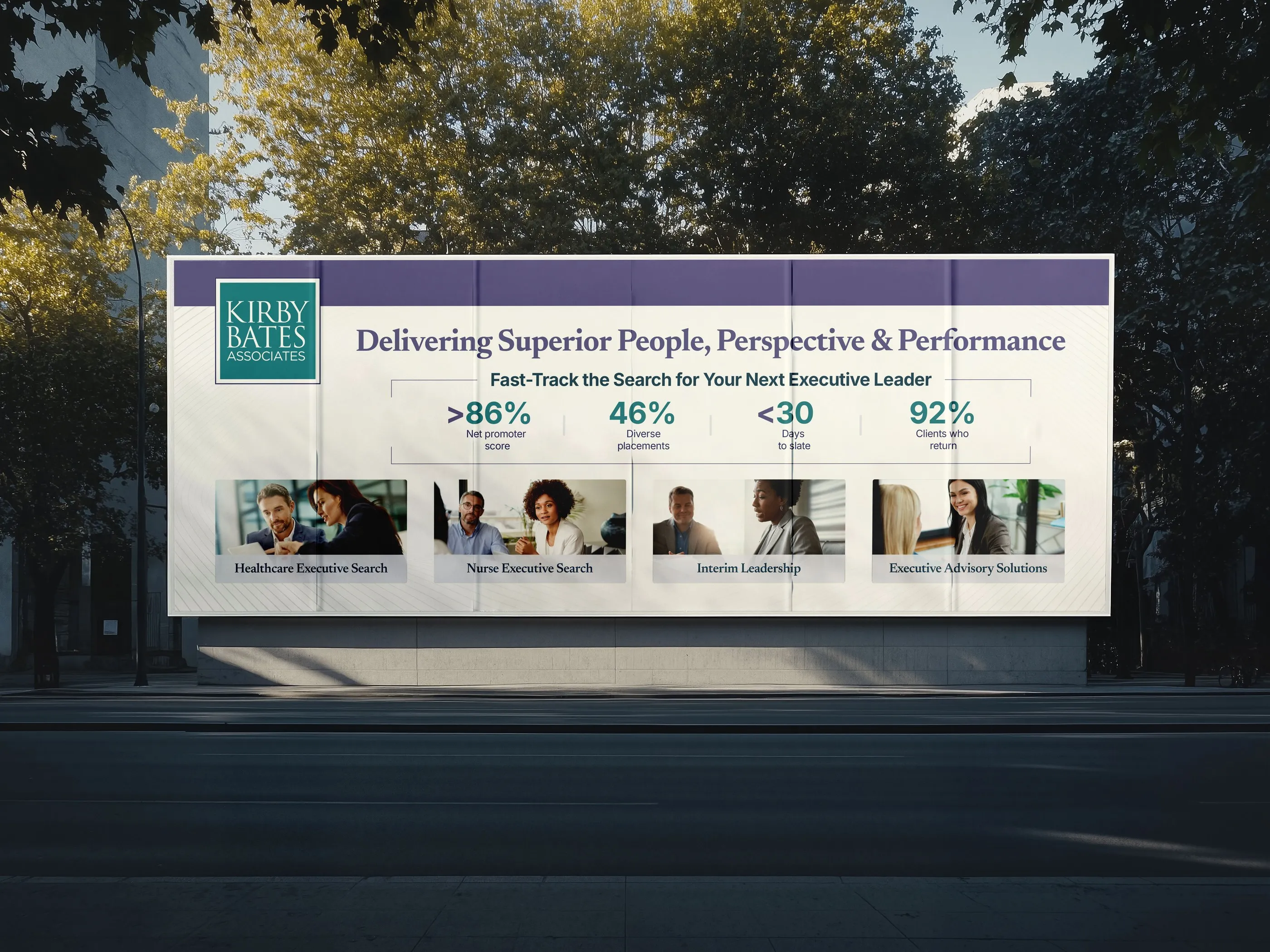 Kirby Bates Associates billboard in a city street: "Delivering Superior People, Perspective & Performance" with four stats and photos of executive search, nurse executive search, interim leadership and advisory services.