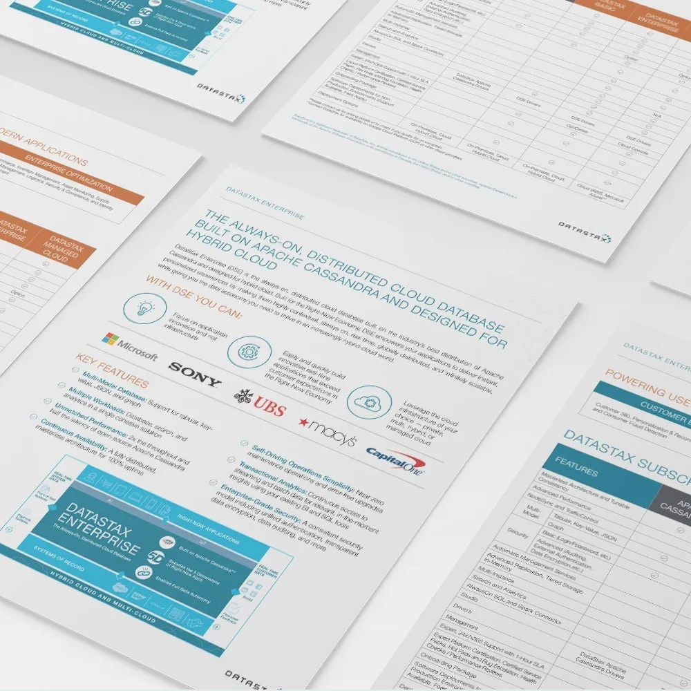 Printed DataStax Enterprise datasheets fanned out on a light grey surface, showing feature lists, customer logos and product tables.