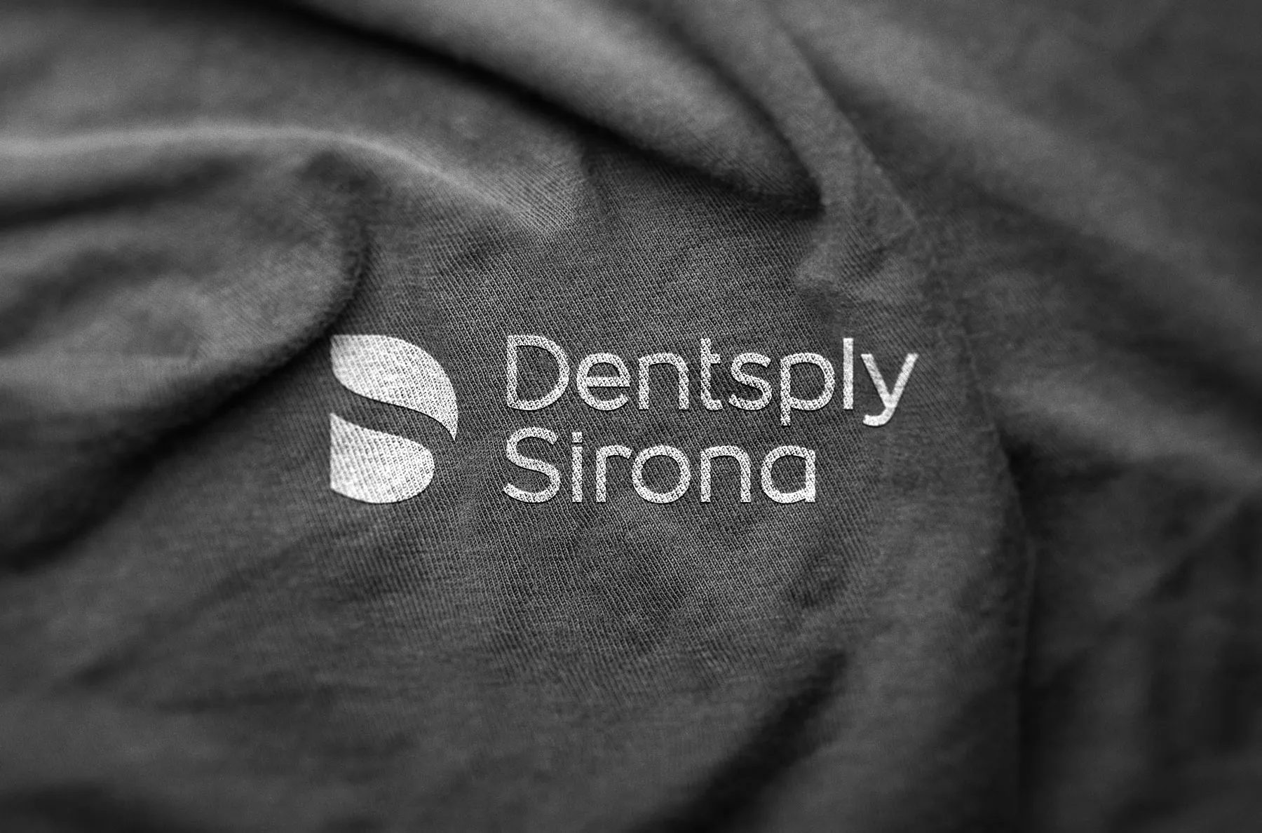 Dentsply Sirona logo embossed on grey fabric.