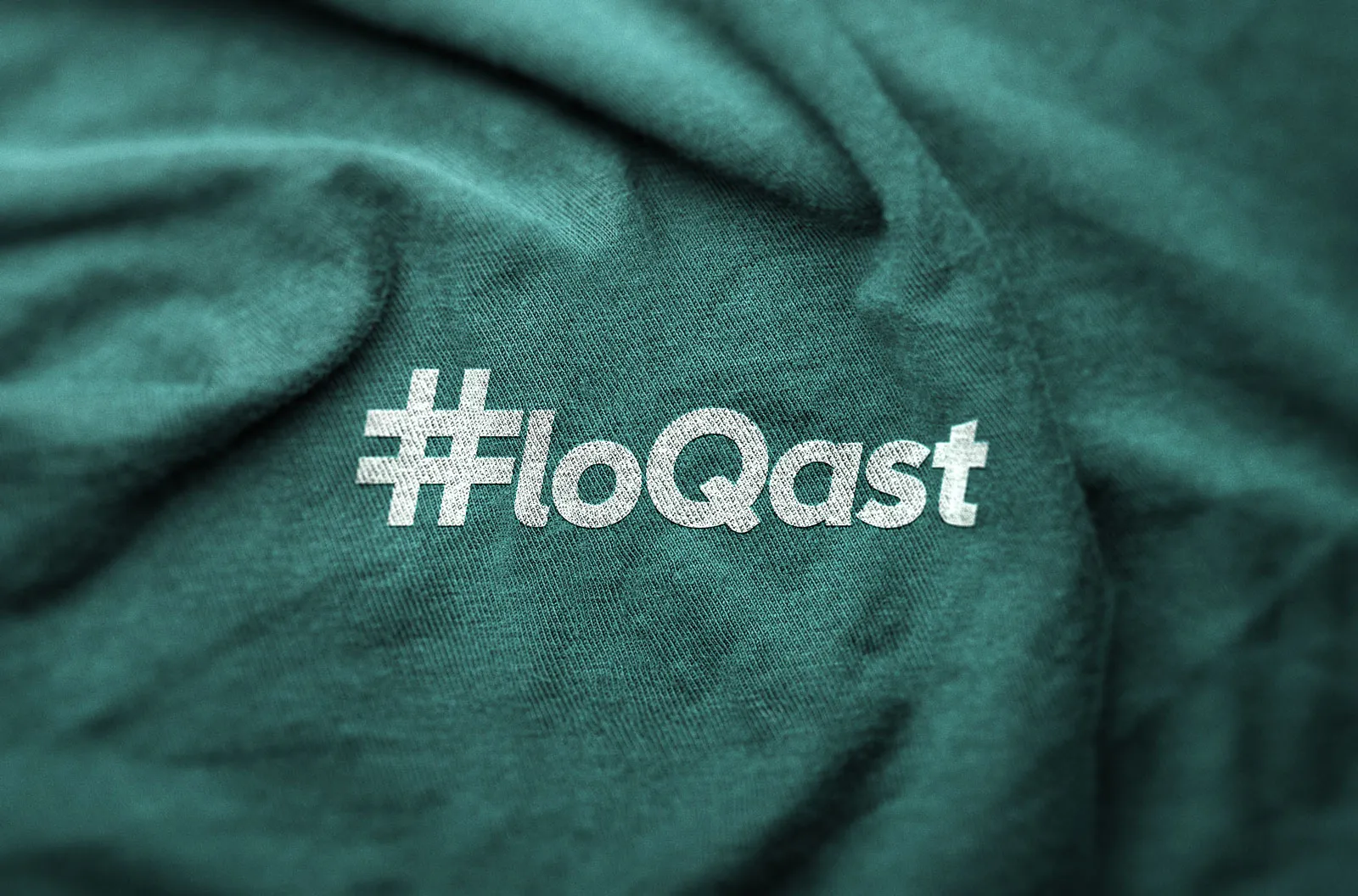 FloQast logo embossed on teal fabric.
