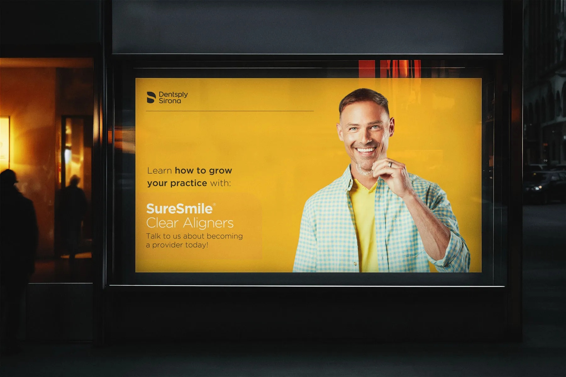 Night-time shelter ad in yellow: "Learn how to grow your practice with SureSmile Clear Aligners".