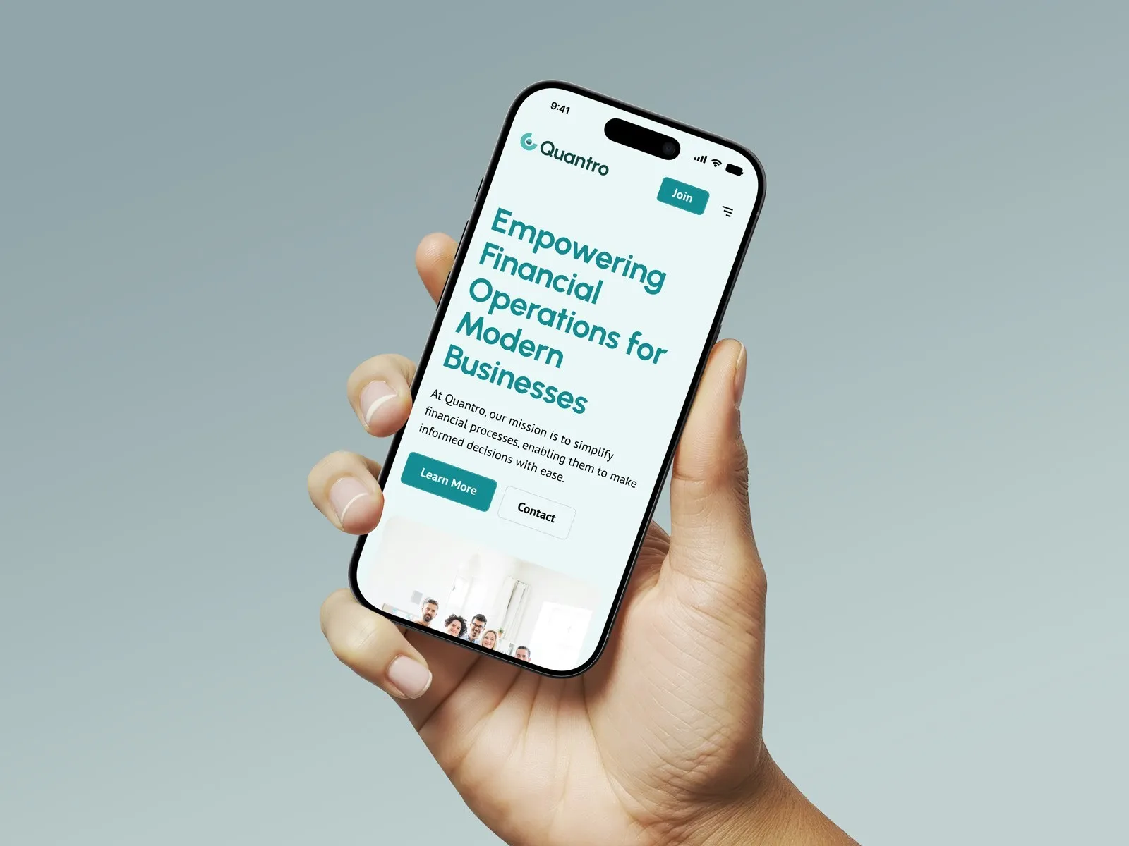 Hand holding a phone showing the Quantro mobile site: "Empowering financial operations for modern businesses".