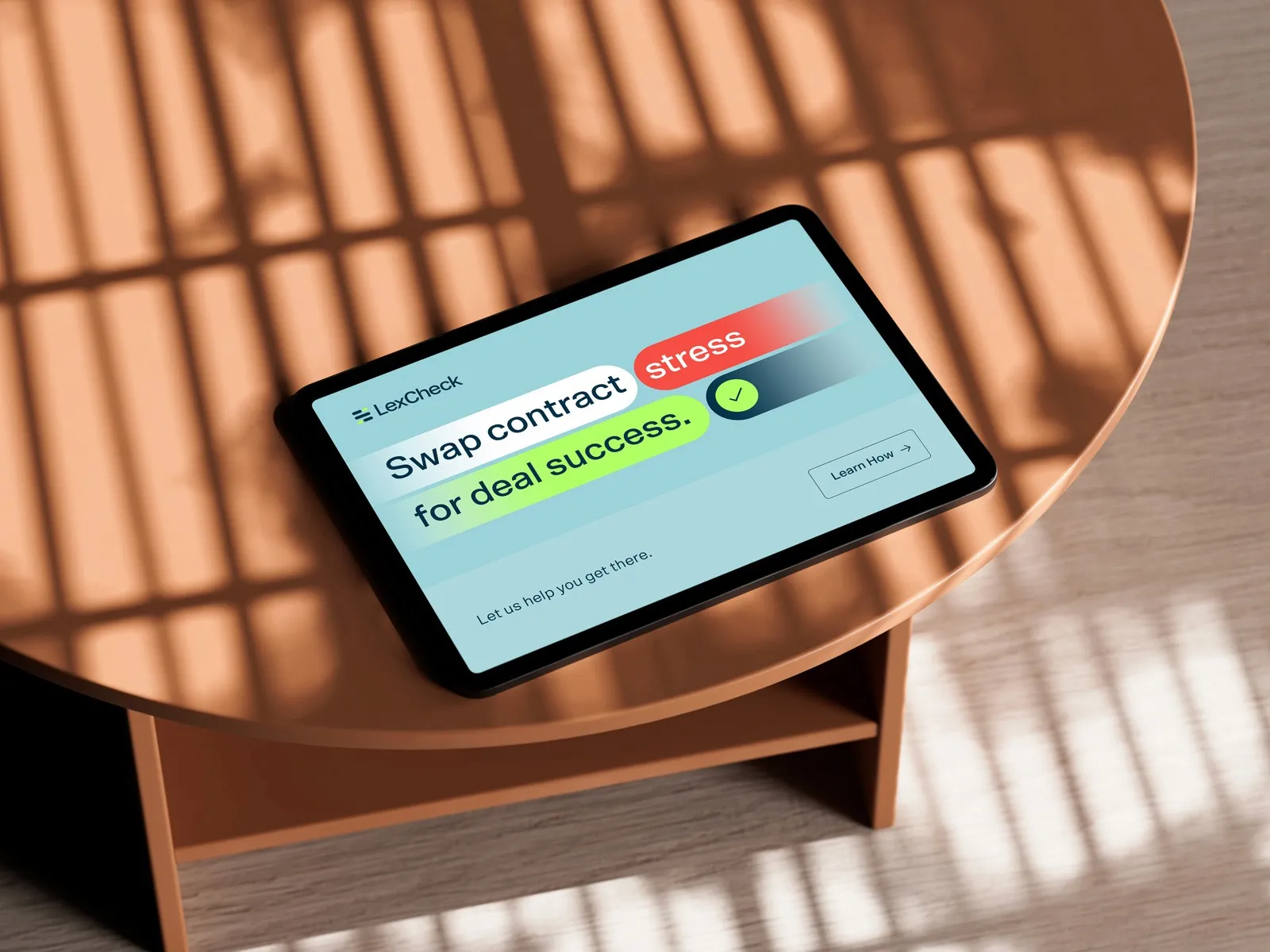 Tablet on a wooden side table showing a LexCheck ad: "Swap contract stress for deal success".
