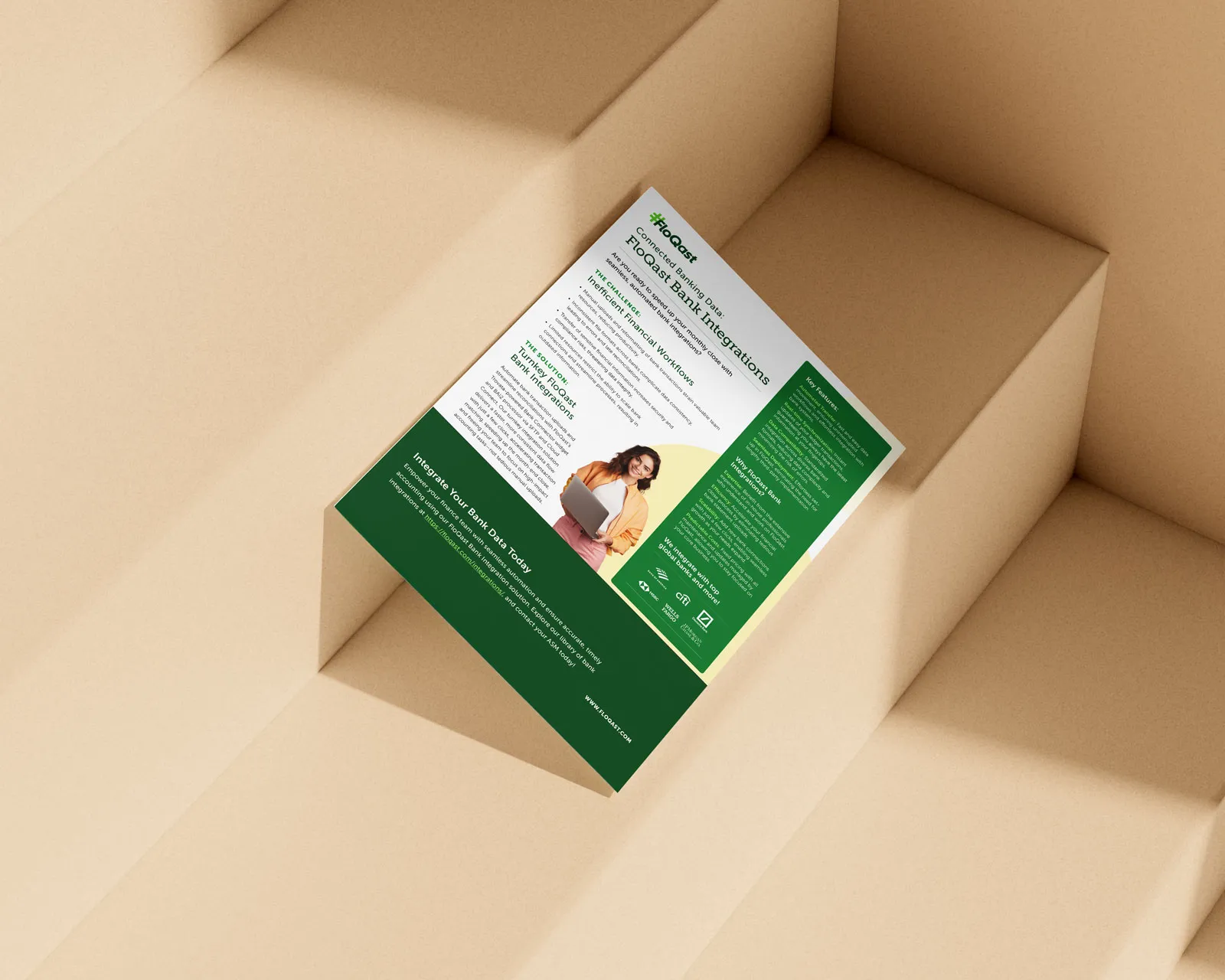 FloQast bank integrations flyer in green and white, propped on cardboard steps.