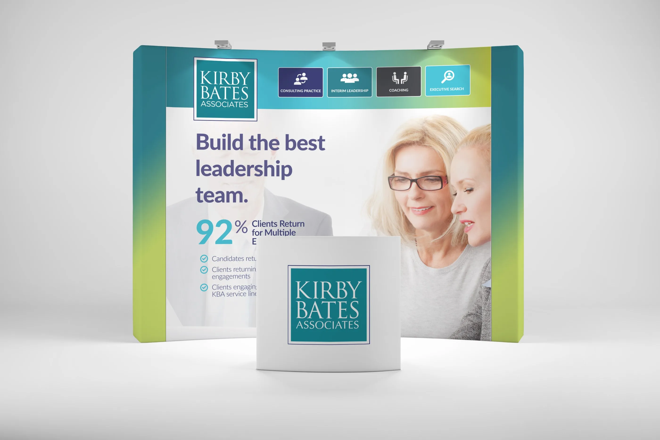 Kirby Bates Associates pop-up booth: "Build the best leadership team" with a 92% client-return stat, two smiling women and a logo counter.