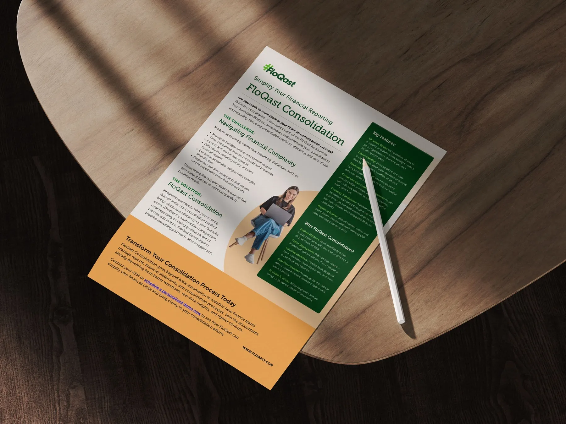 FloQast financial consolidation flyer in green and orange on a wooden table with a stylus.