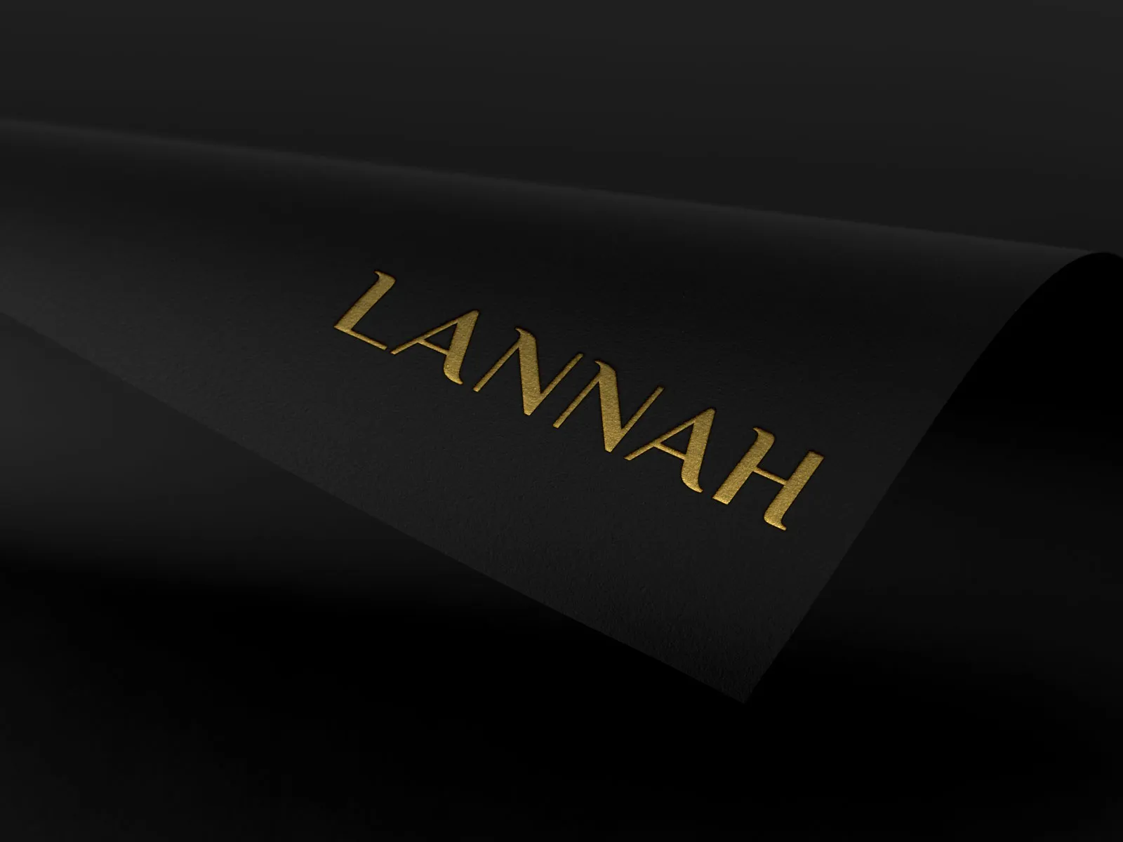 Lannah wordmark foil-stamped in gold on black paper.