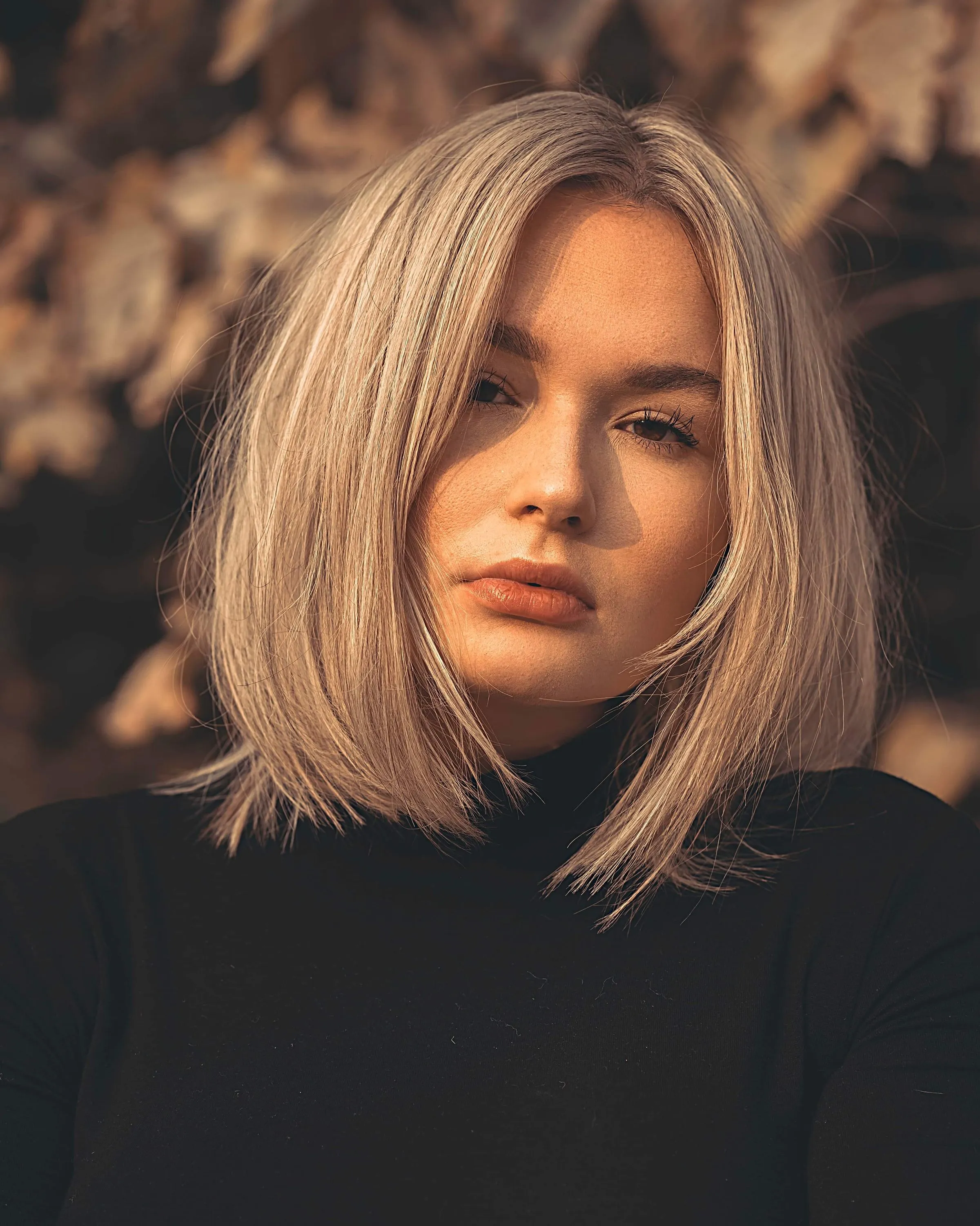 A soft blonde bob just above the shoulders.