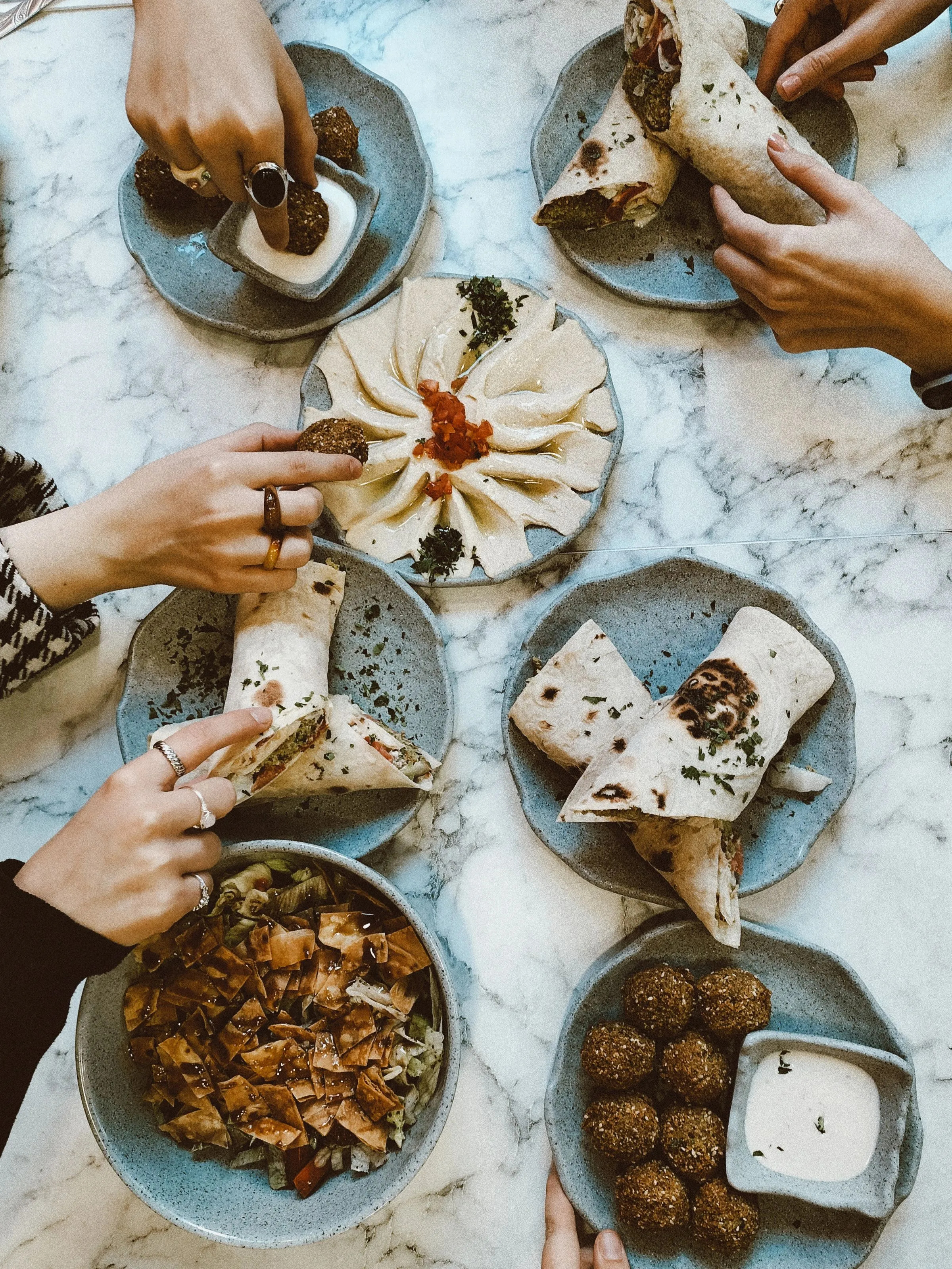 Falafel, wraps and dips seen from above.