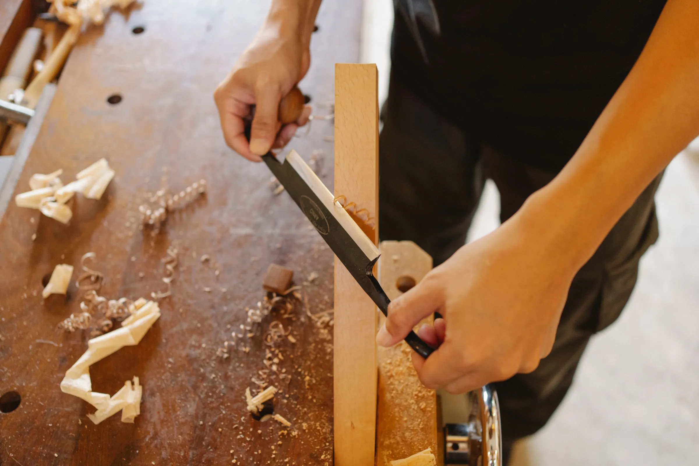 Shaping a piece of wood with a chisel.