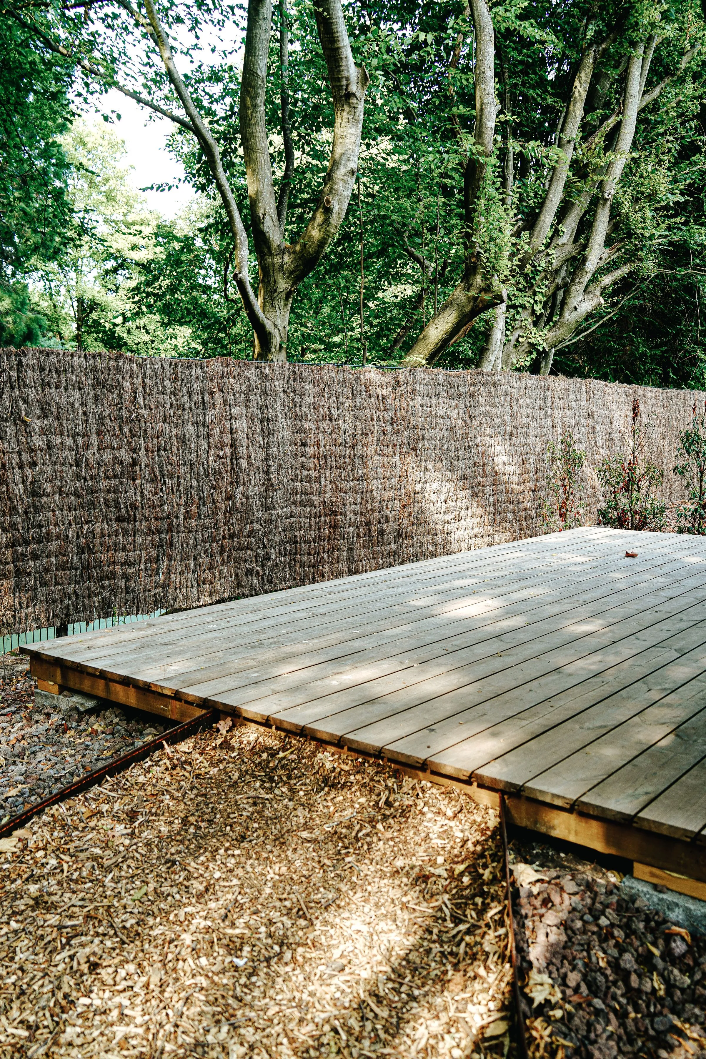A new low deck built in a leafy back garden.
