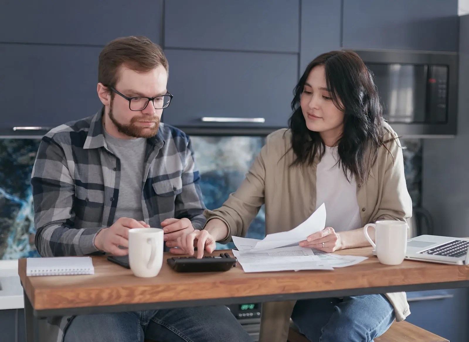 Andrew and Lauren Bennett reviewing paperwork together at their kitchen table