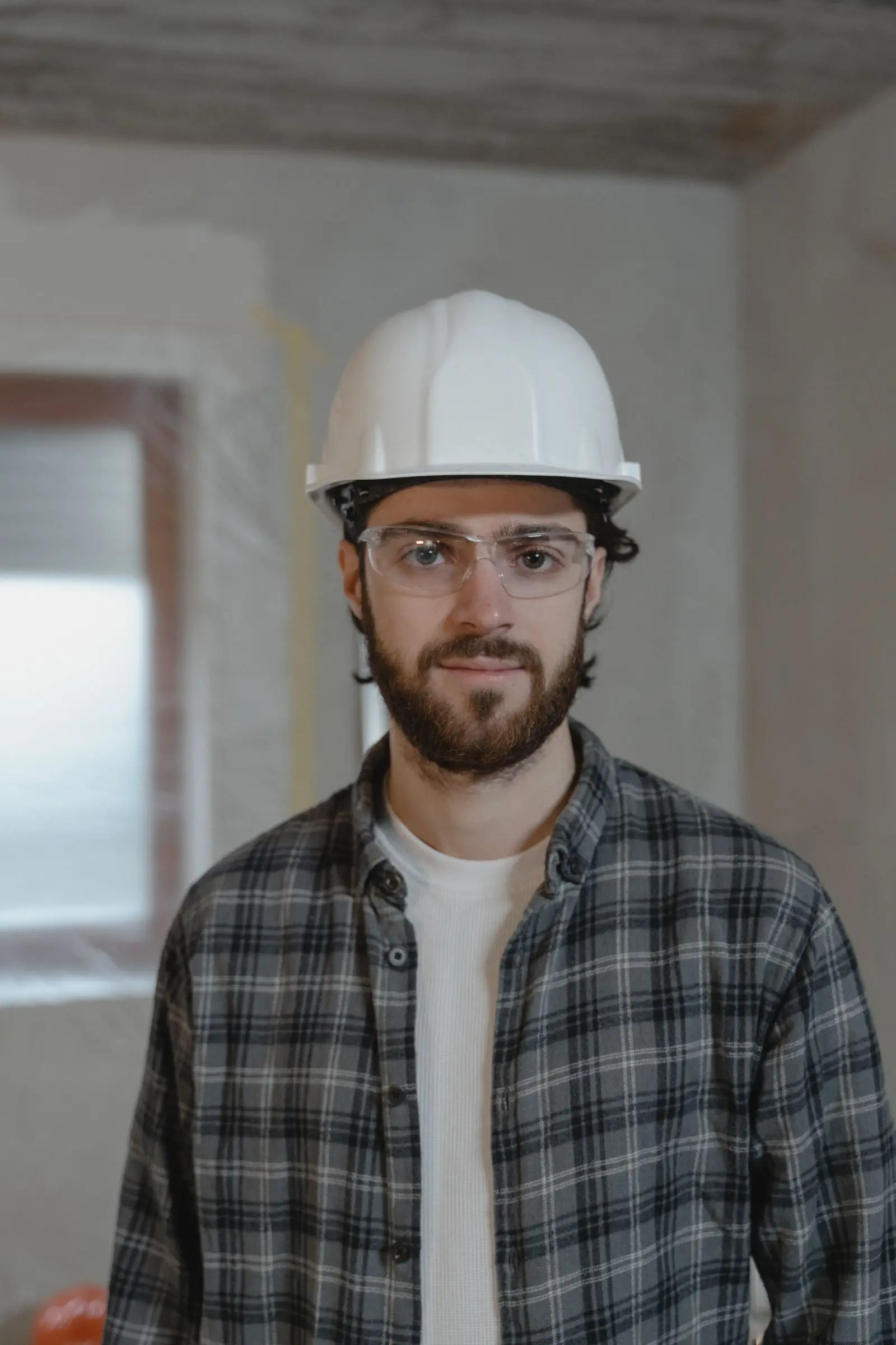 Ryan Hartley of Hartley Builders in a white hard hat and safety glasses