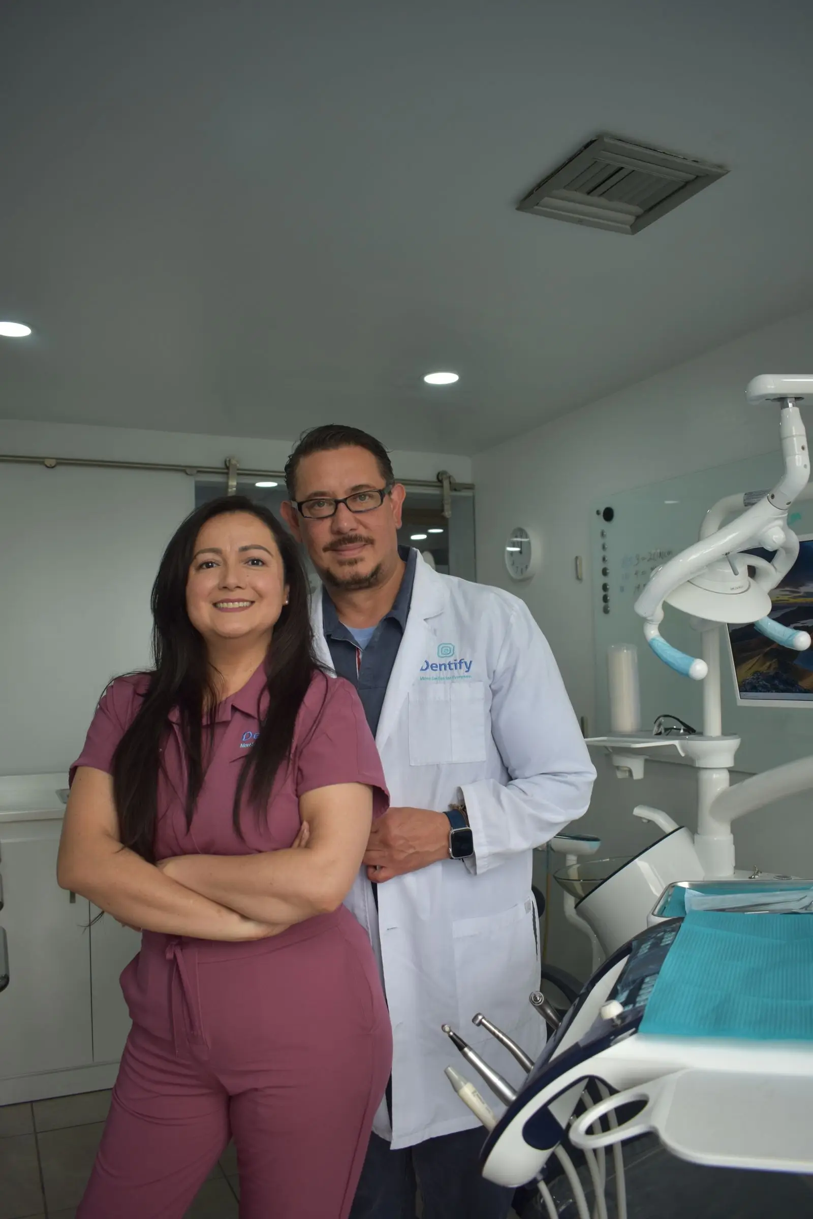 Dr. Karen Whitaker and Dr. Tom Whitaker standing in a treatment room at their dental practice