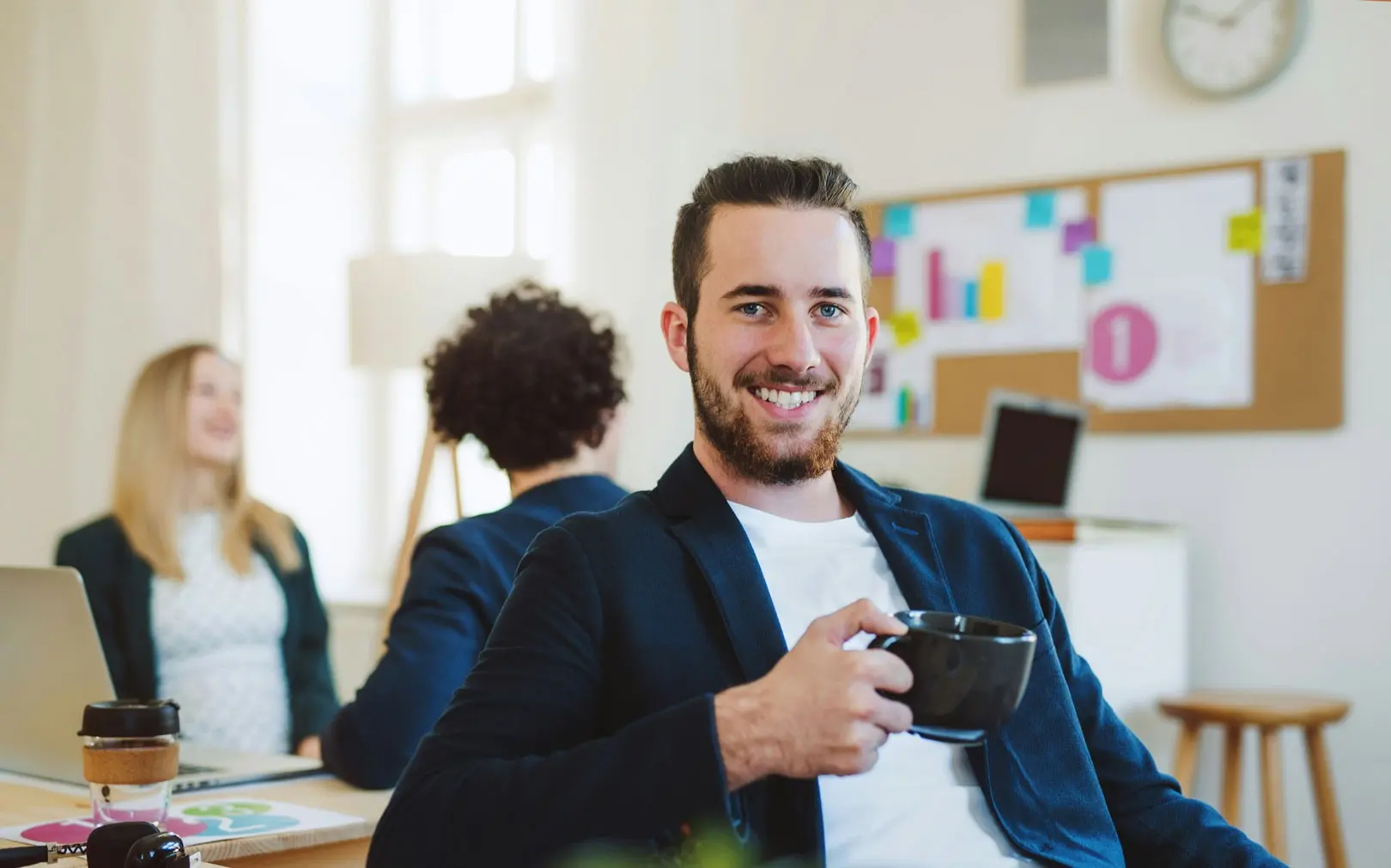 Portrait of Jason Miller holding a coffee mug